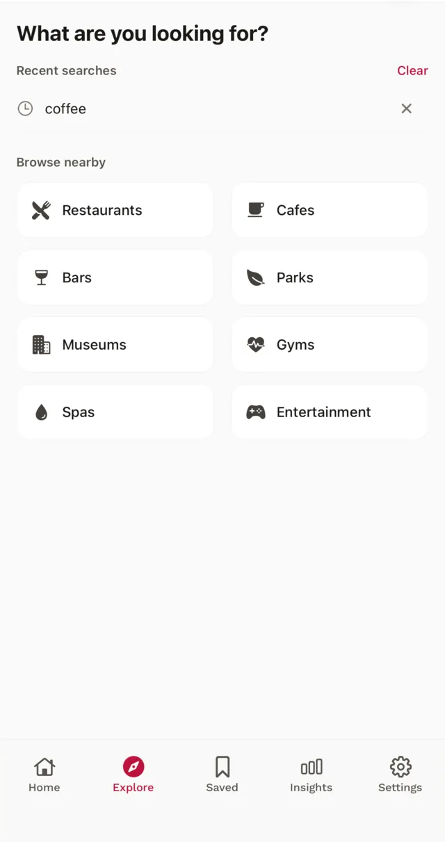 Explore screen with a search box, a recent search for coffee, and nearby categories such as restaurants, cafes, bars, parks and museums.